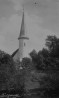 Vaade läbi puude Lüganuse kirikule. Hästi näha ümartorn kukega. Aasta: 1930. #F 32117